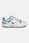 M-100 Low sneaker side view in white and sky blue – full‑grain leather upper with mesh air vent insert, sky blue overlays, PONY chevron and chunky rubber sole.